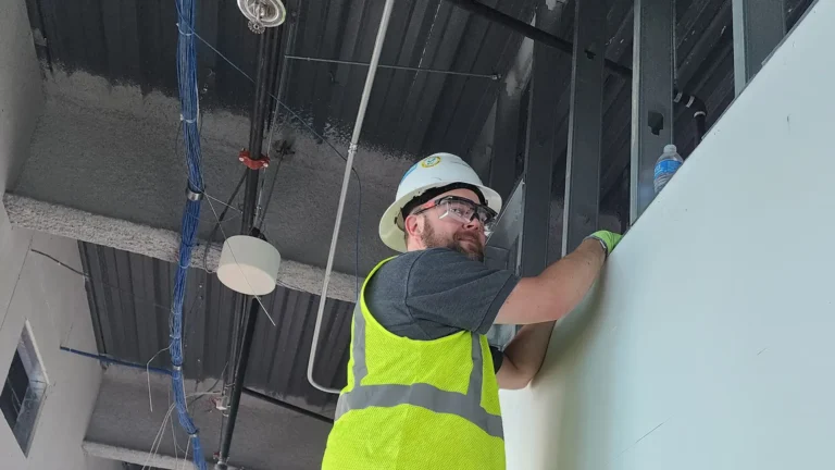 Field technician installing conduit and cable for security system