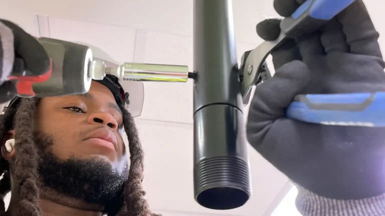 Installer securing conduit for ceiling-mounted security device